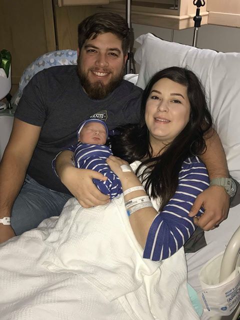 smiling parents with newborn